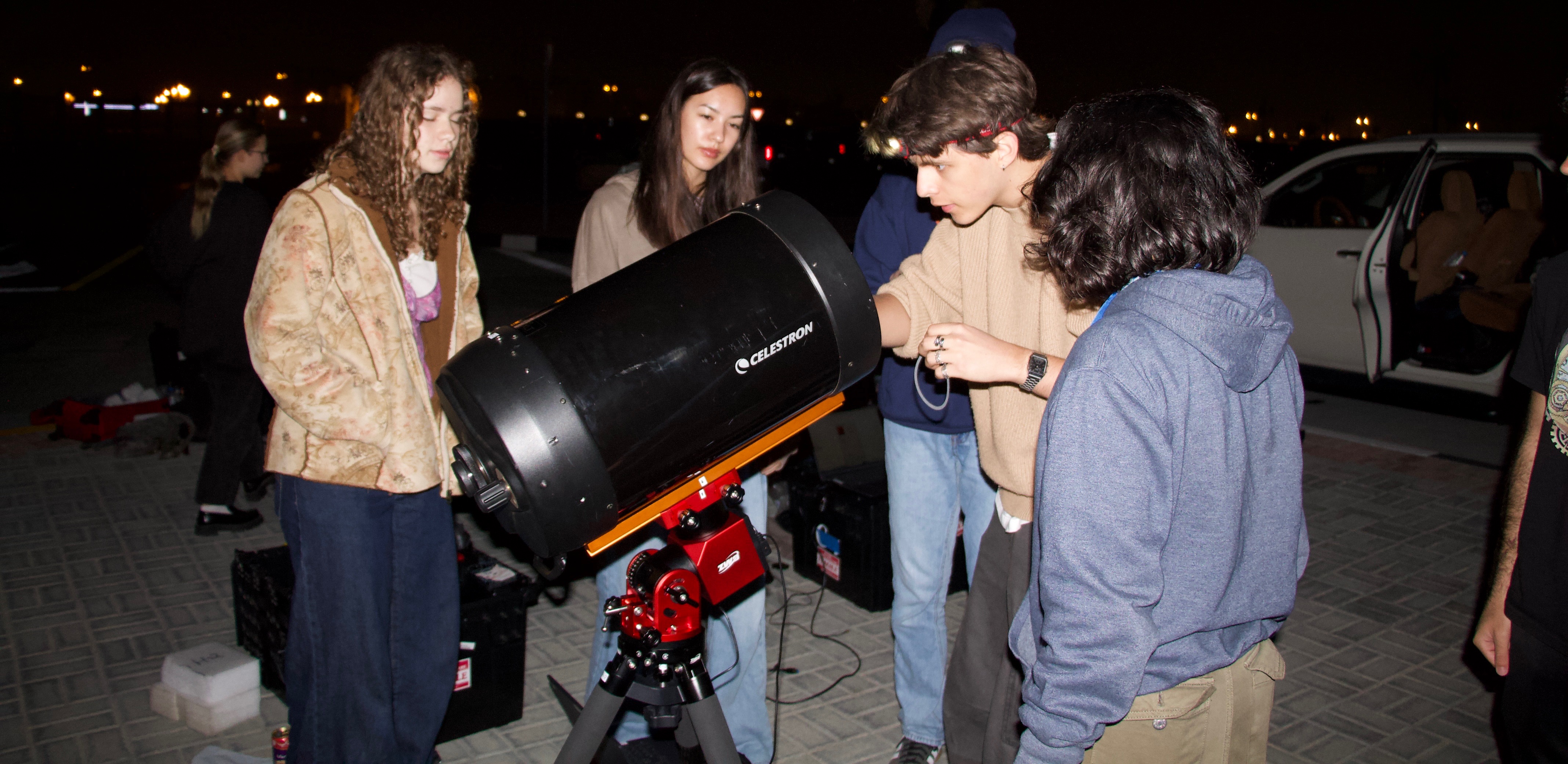 Group members working together to set up a telescope